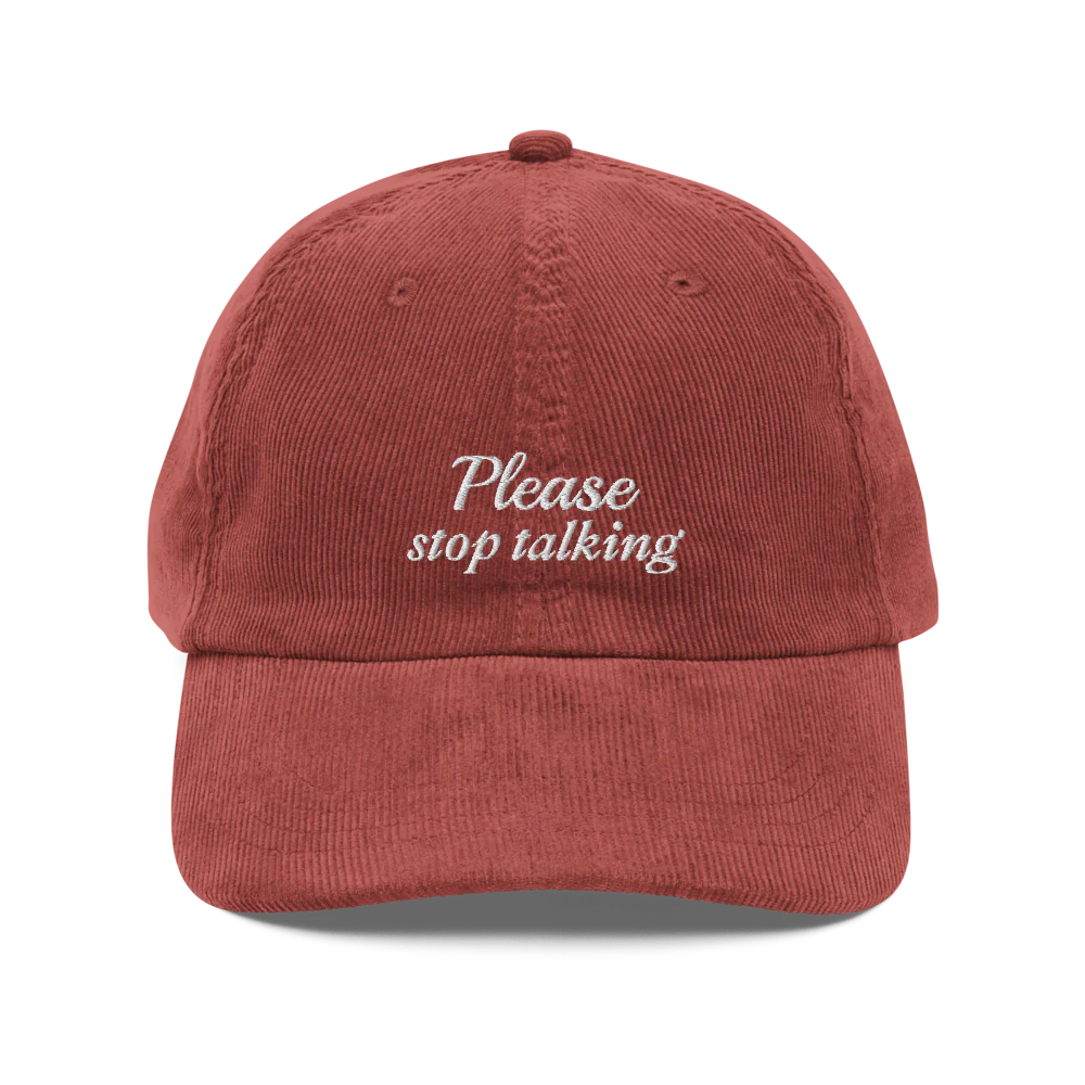 Red corduroy baseball hat with "Please stop talking" embroidered in white.