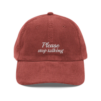 Red corduroy baseball hat with "Please stop talking" embroidered in white.
