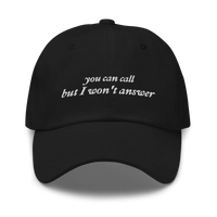Black baseball hat with white embroidered text 'you can call but I won't answer' on a white background
