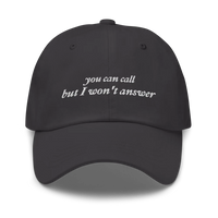 Gray baseball hat with white embroidered text 'you can call but I won't answer' on a white background